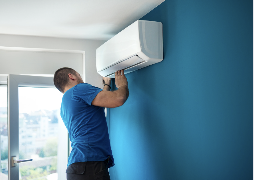 Man checking AC because is blowing warm air