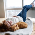 Woman and her cat resting in front of an HVAC unit. Featured image for “What to Do When Your HVAC Unit Freezes in Winter”